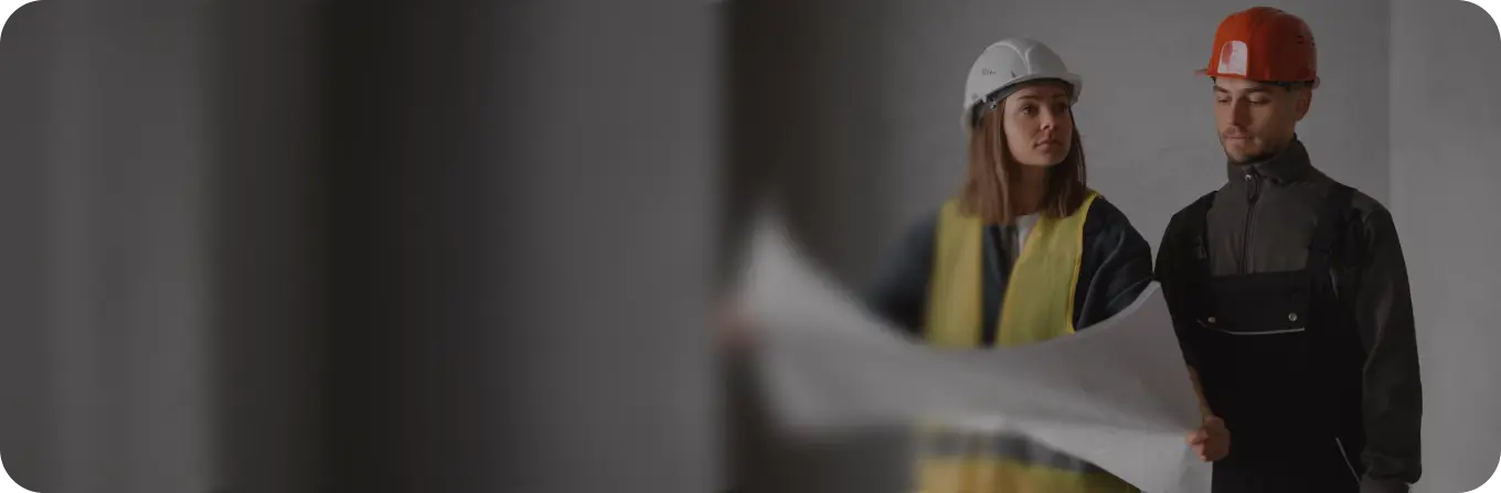 Construction workers with blueprints